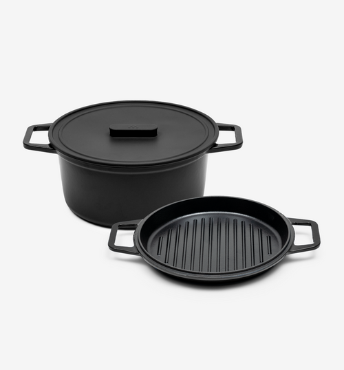 Black cast iron Dutch oven with lid and grill pan set